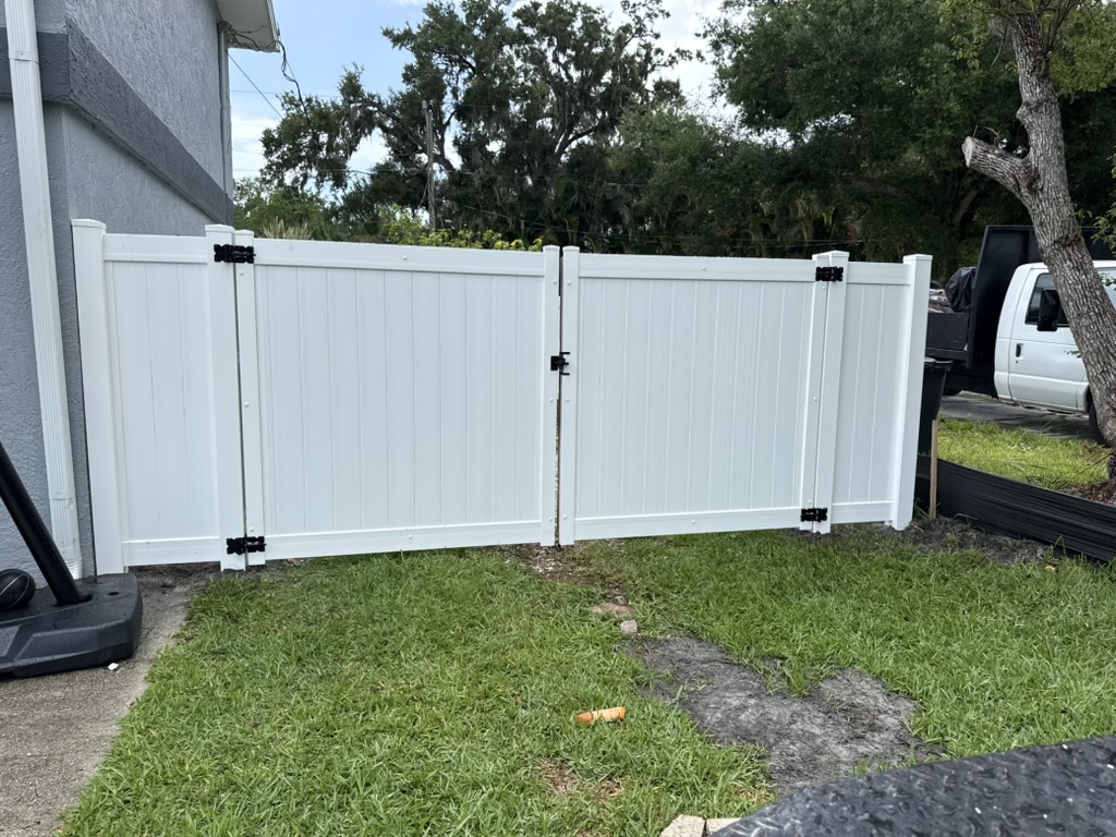 White vinyl double drive gate with privacy panels