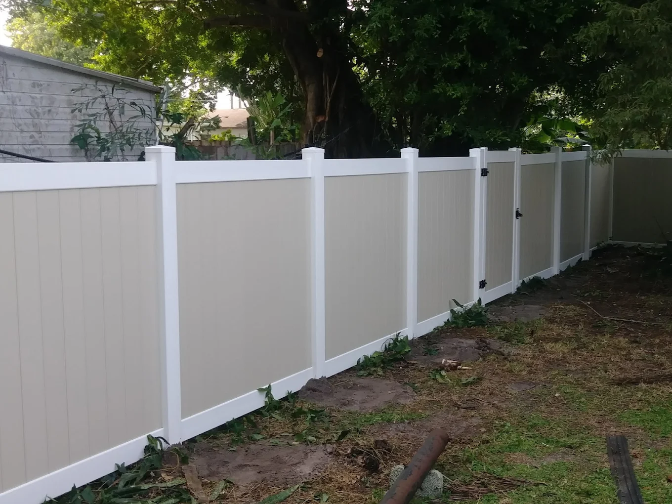 Two-tone vinyl privacy fence with matching walk gate