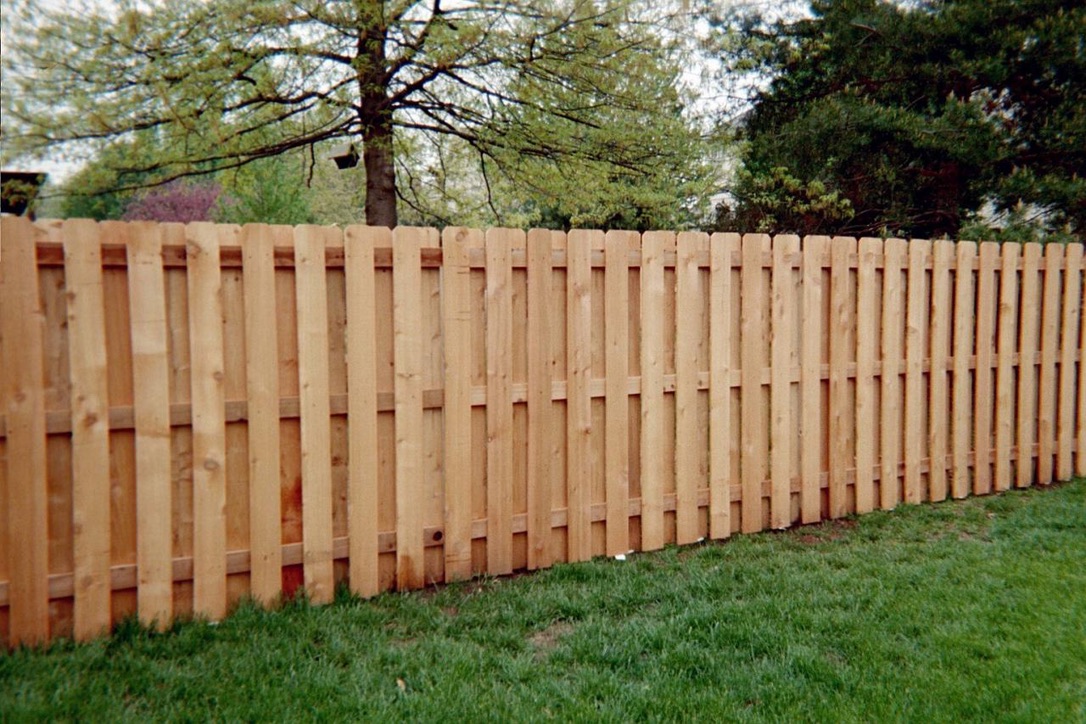 Cedar-tone wood shadowbox fence
